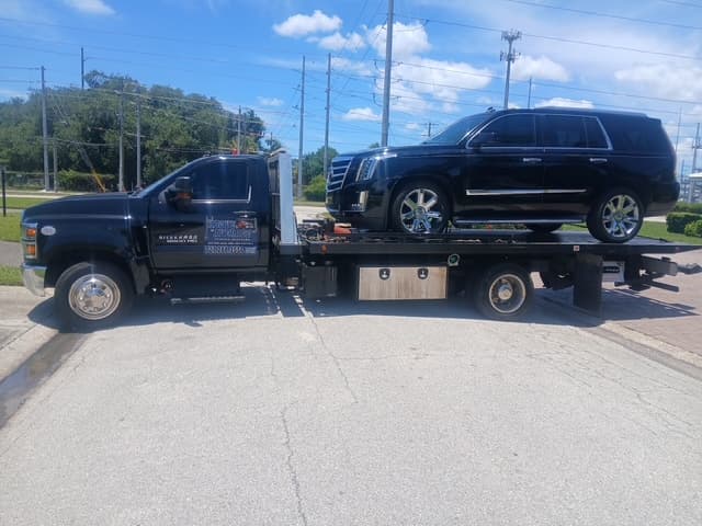 Cadillac Escalade secured on the flatbed for a transport run